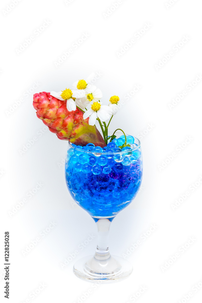 Beautiful flowers in wine glass with hydrogel isolated on white