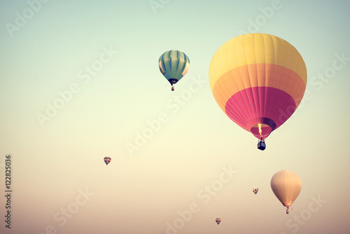 Colorful hot air balloons flying on sky with fog - retro filter effect style