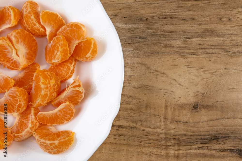 fresh tangerine slices on a white plate fresh tangerine slices on a white plate