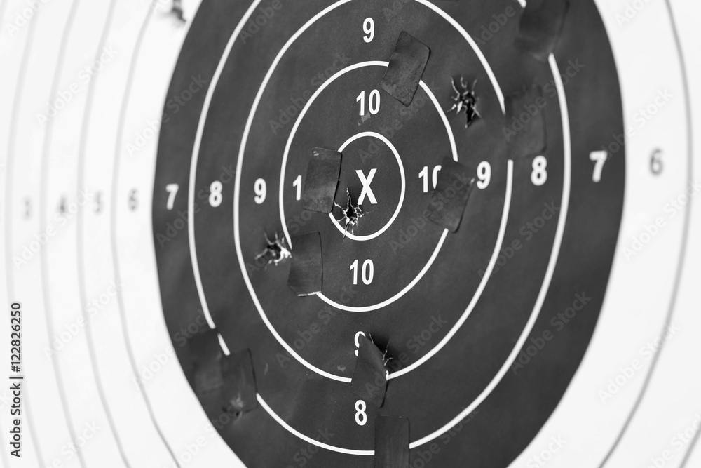 Naklejka premium Holes in a shooting practice target. Target With Hits.