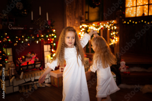 Girls sister friends dancing Christmas tree, concept of Christ