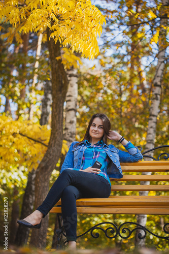 beautiful girl with long black hair in the autumn park