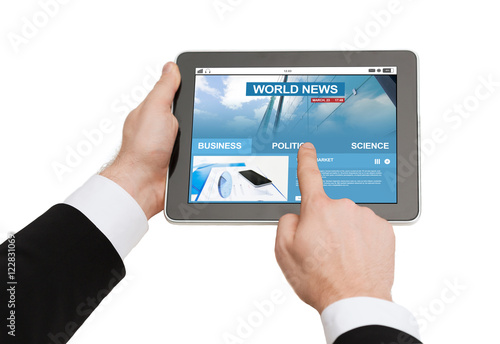 close up of hands with business news on tablet pc
