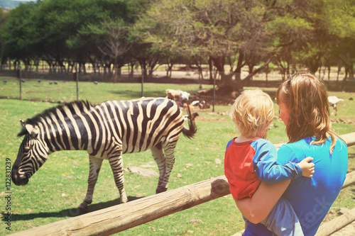 mother and little son looking at zeebra photo