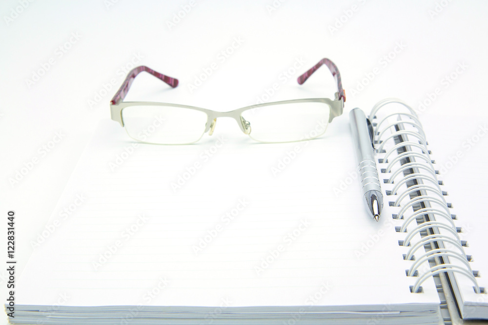 Education and office concept. Pen notebook and eyeglasses Education and office concept. Pen notebook and eyeglasses