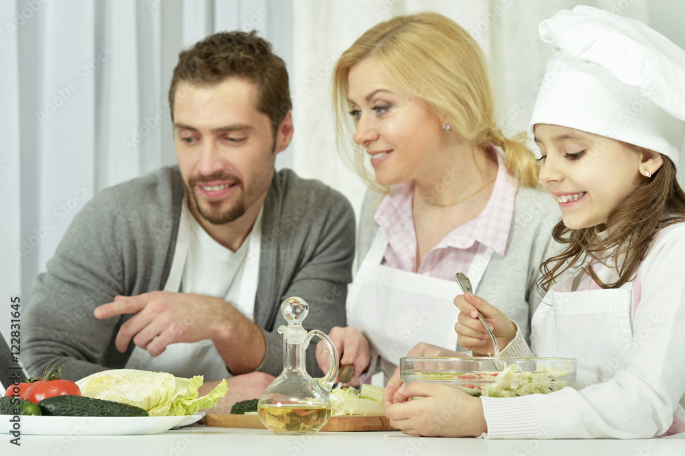 family with daughter cooking in kitchen family with daughter cooking in kitchen
