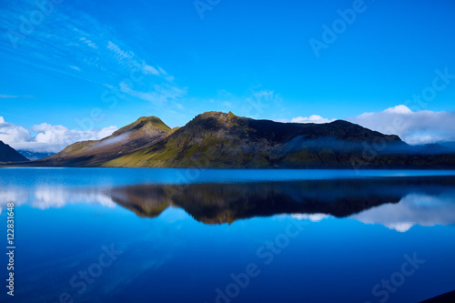 Lake coast with mountain reflection at the sunrise, Iceland