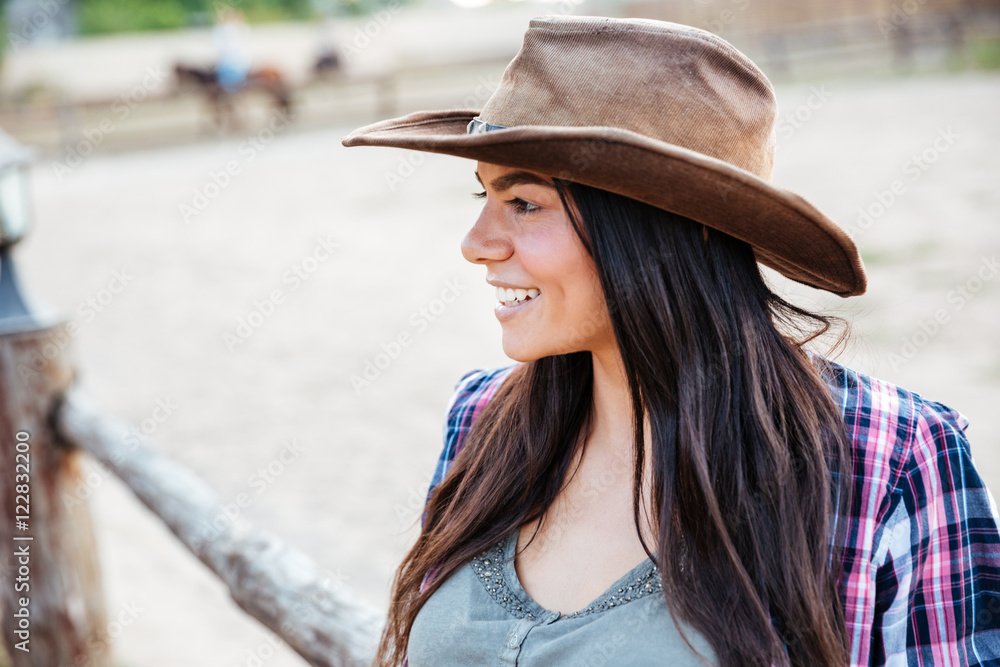 Smiling pretty young woman cowgirl in hat