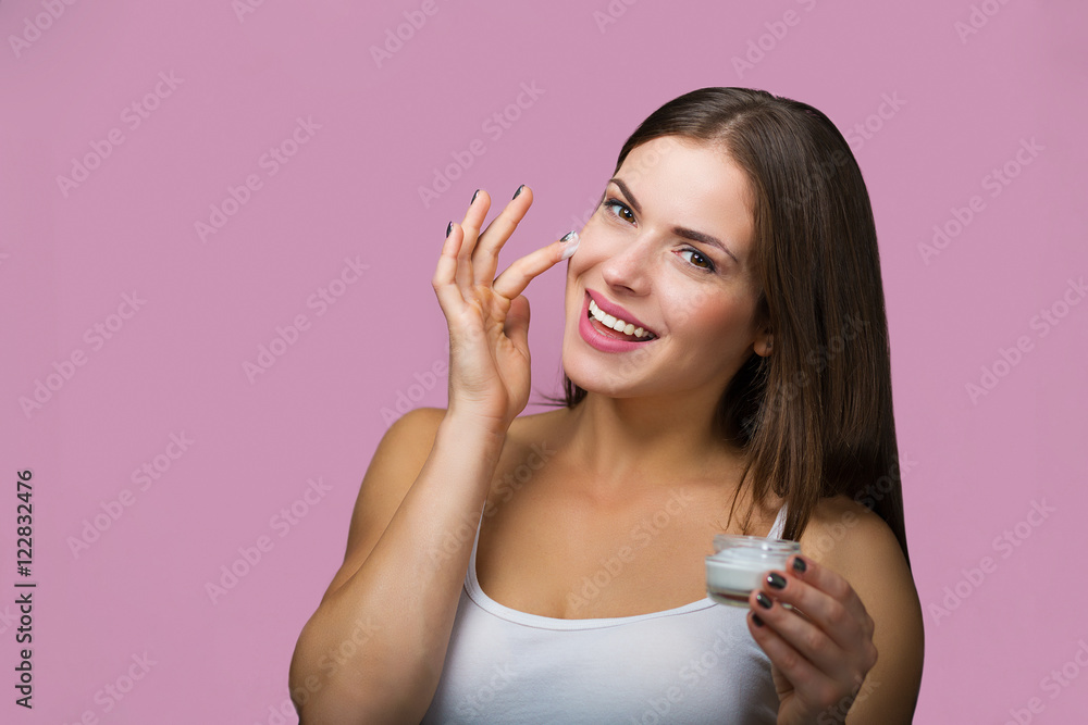 Woman with a skin care product Woman with a skin care product