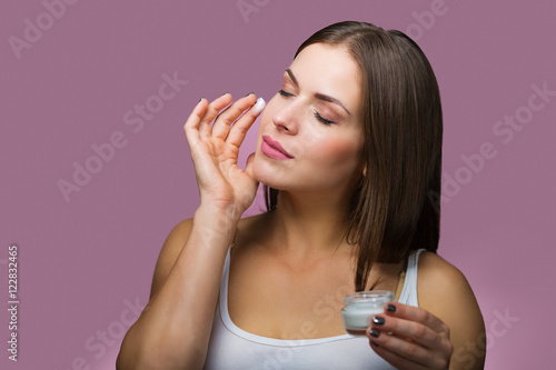 Woman with a skin care product