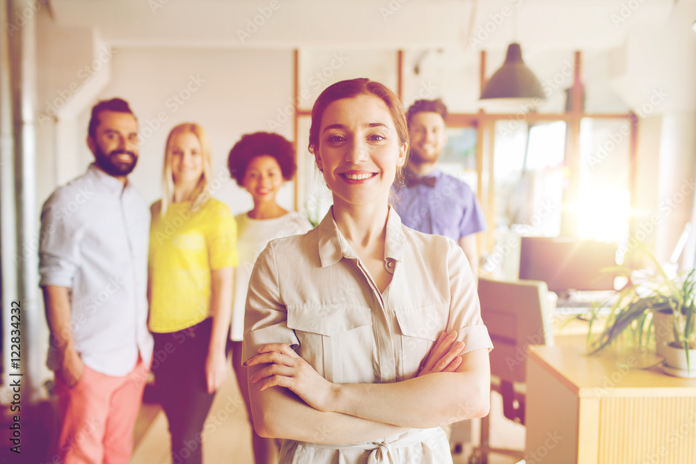 happy young woman over creative team in office happy young woman over creative team in office
