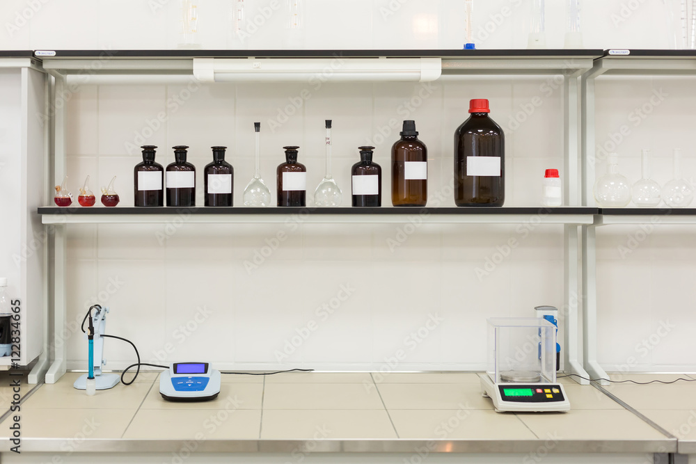 Brown bottles on a shelf in the laboratory. Brown bottles on a shelf in the laboratory.