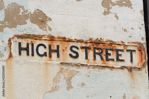High Street sign on wall going rusty from sea water erosion