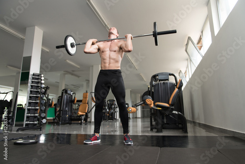 Healthy Man Doing Exercise Barbell Squat