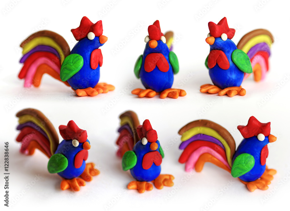 Set of plasticine cocks in different views. Modeling clay roosters isolated on white background. Chinese symbol of New Year 2017.