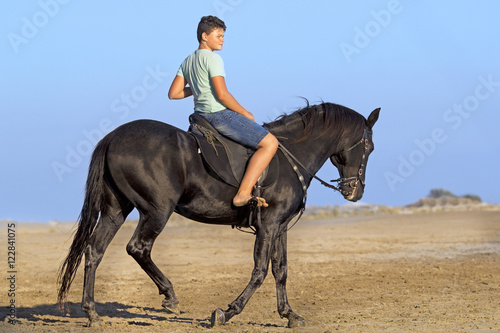 young rider on the beach