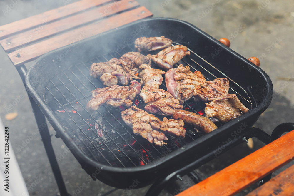 Grill steaks on metal grate with flame, barbecue