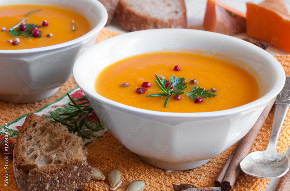 Pumpkin soup in a white bowl with bread Pumpkin soup in a white bowl with bread