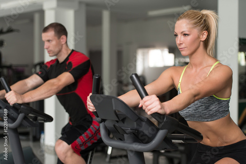 Healthy People On Bicycle In Fitness Gym