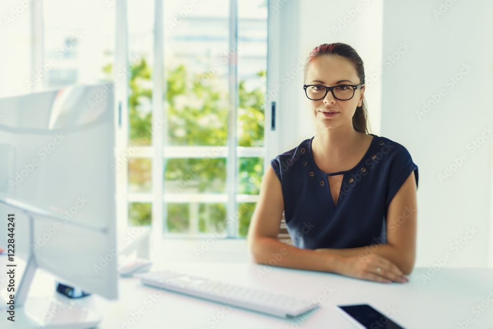 Portrait of natural professional woman in office. Looking at camera Portrait of natural professional woman in office. Looking at camera