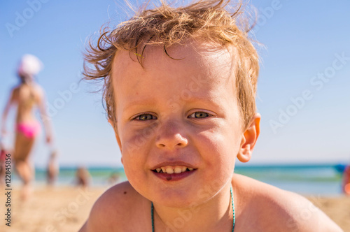 Portrait of boy in golden grass near sea © sacura14
