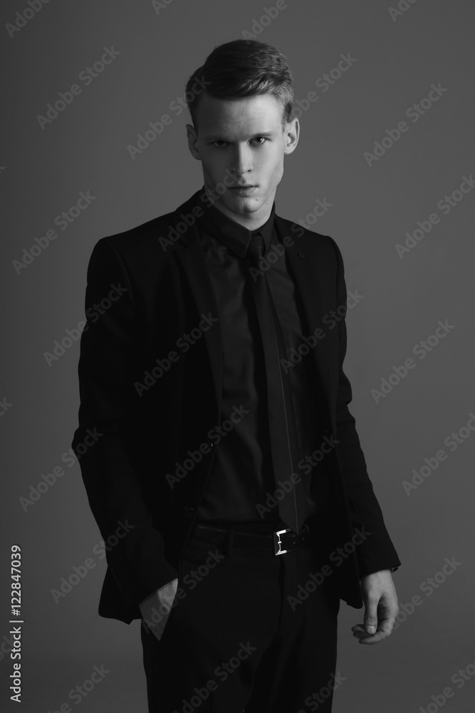 Stylish man, poses elegant in full costume in the studio, isolated on a  white background. horizontal indoors shot. Young man | CanStock