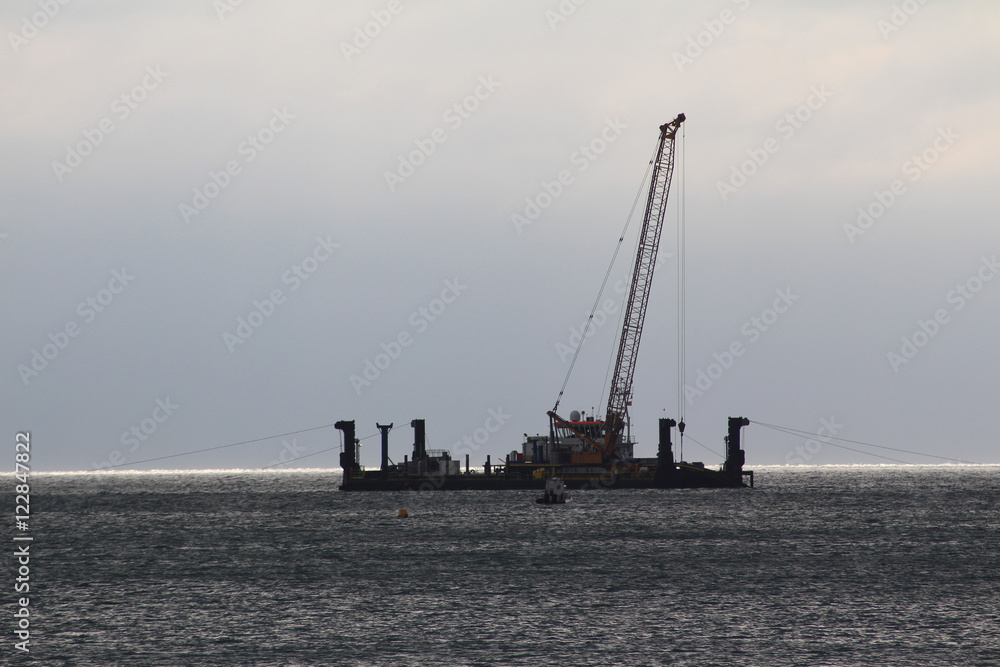 Cable laying rig off the coast of Sussex for the 116 wind turbine farm 10 miles off the coast