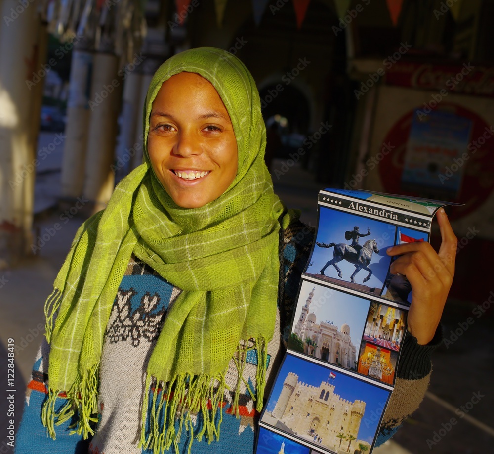 Φωτογραφία ALEXANDRIA - EGYPT - DECEMBER 2009: Portrait of a smiling girl in a green shawl,