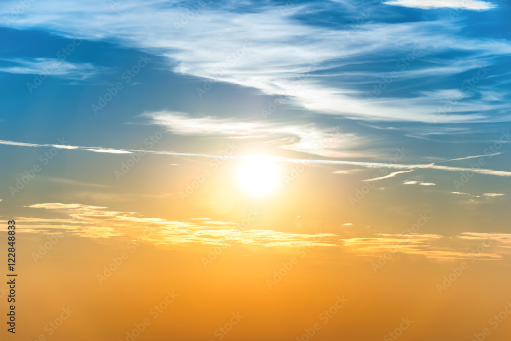 Fototapeta premium Sunset in the sky with blue orange clouds