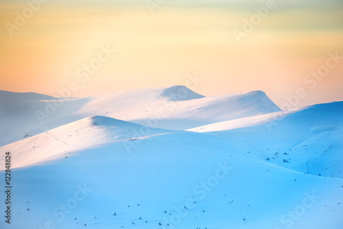 Sunset over hills with snow