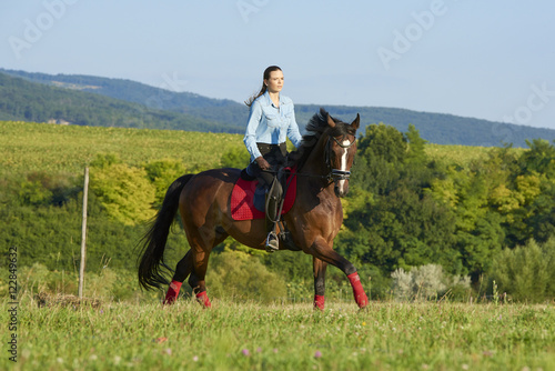 Beautiful woman on a horse © gzorgz