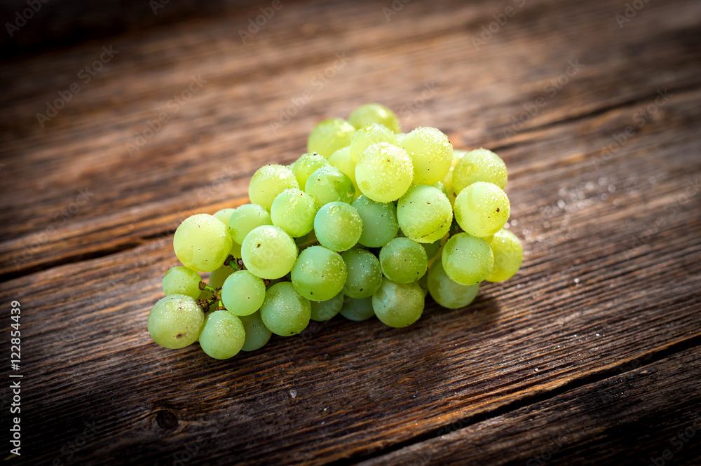White grapes on wooden background White grapes on wooden background