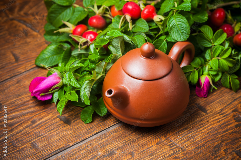 Healthy tea with a dogrose on wooden table
