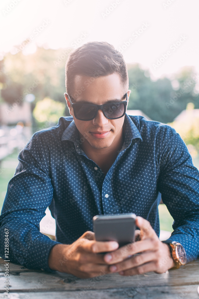 Young man using mobile phone Young man using mobile phone