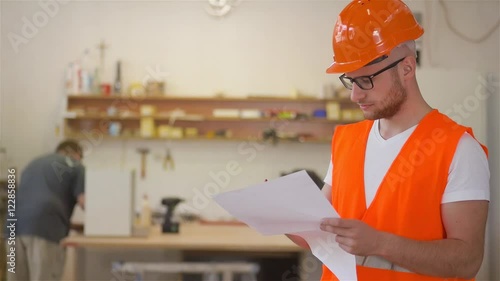 Carpenters is analyzing construction plans using documents.