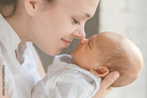 Newborn baby boy in mother's arms
