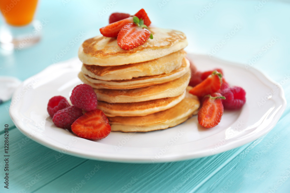 Tasty pancakes with berries on plate Tasty pancakes with berries on plate