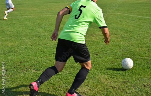 Fototapeta Naklejka Na Ścianę i Meble -  Soccer player runs with a ball