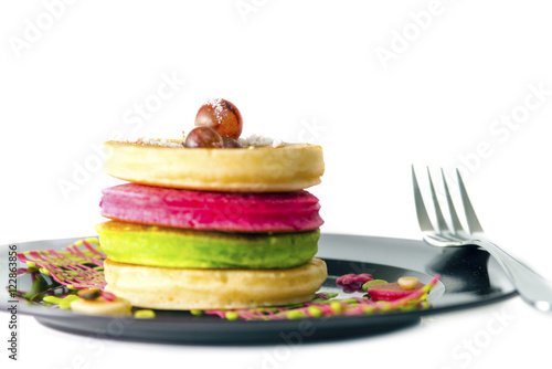 stack of pancakeswith grape in black dish i photo