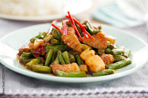 Stir fried pork and red curry paste with sting bean photo