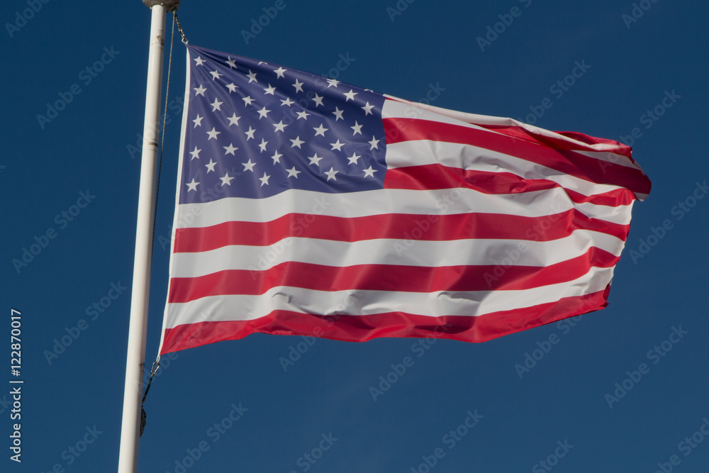 American flag on the blue sky waving