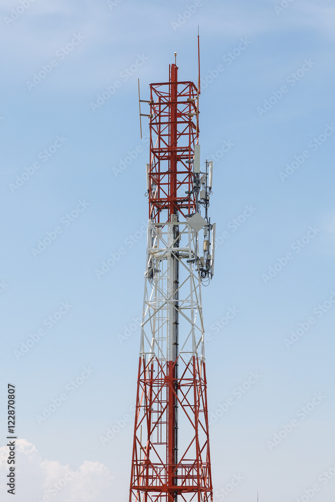 Radio antenna with clouds and blue sky background