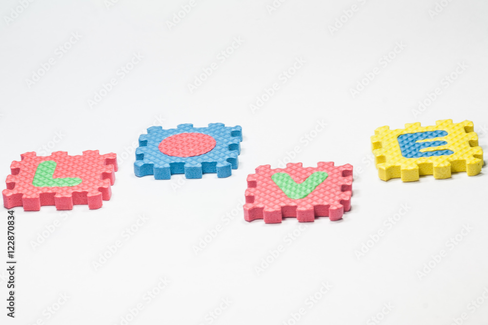 Puzzle pieces with word love on a white background. Puzzle pieces with word love on a white background.