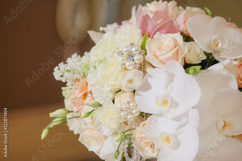 Bouquet made of flowers in pastel tones and decorated with pearl