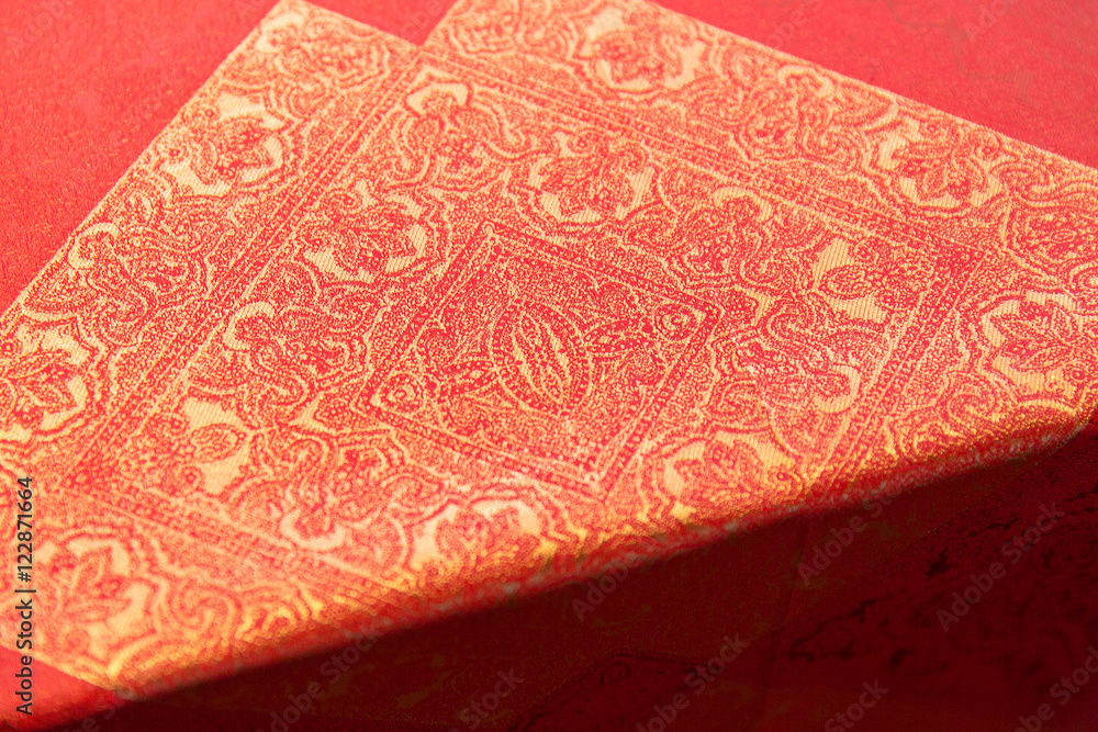Fototapeta premium Golden orienal design on an orange tablecloth