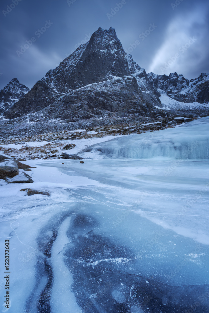 Frozen waterfall and mountain on the Lofoten in northern Norway