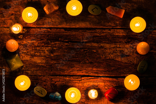 candles, stones for divination and runes on wooden background mockup