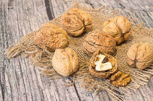  Giant walnuts. Giant walnuts on sackcloth on an old wooden table.