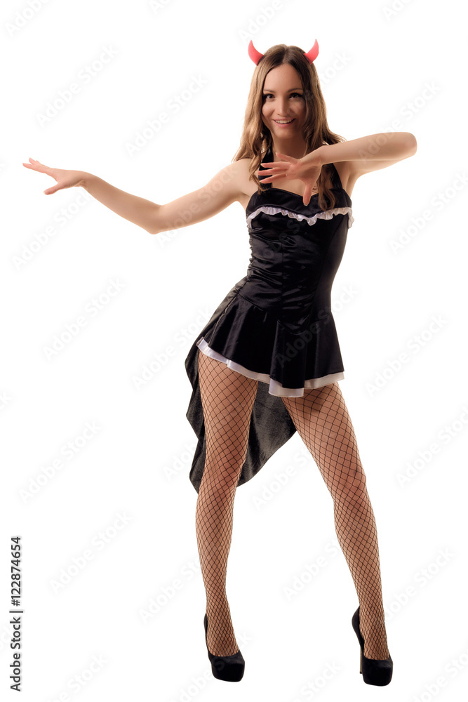young woman in a witch costume posing in studio young woman in a witch costume posing in studio