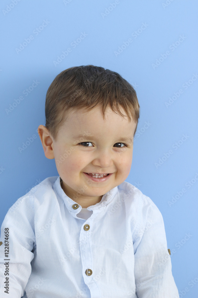 happy baby smiling in a blue background happy baby smiling in a blue background